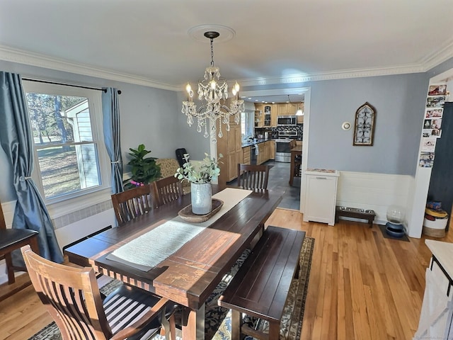 4380 Whitney Ave, Hamden, CT 06518 - dining space with a chandelier, ornamental molding, light wood finished floors, and a wainscoted wall