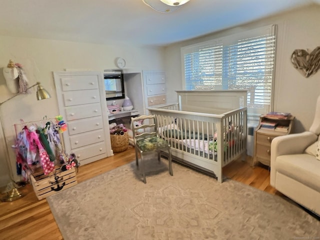 4380 Whitney Ave, Hamden, CT 06518 - bedroom with light wood-type flooring and a nursery area