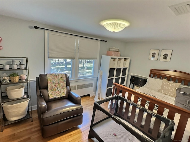 4380 Whitney Ave, Hamden, CT 06518 - bedroom with radiator heating unit and wood finished floors
