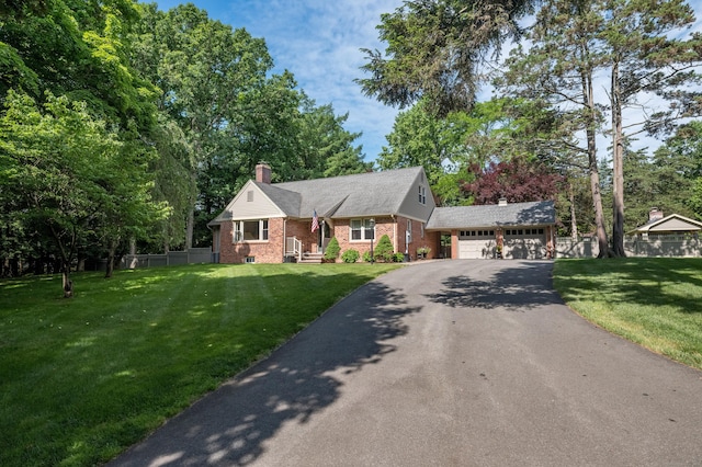 4380 Whitney Ave, Hamden, CT 06518 - view of front of home with asphalt driveway, brick siding, and a chimney