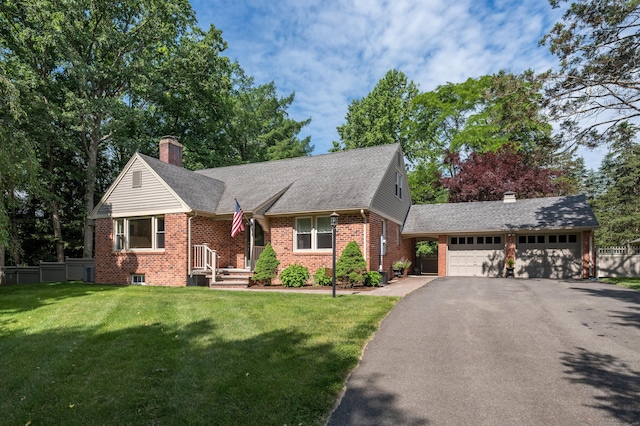 4380 Whitney Ave, Hamden, CT 06518 - view of front of house with brick siding, a chimney, asphalt driveway, and a garage