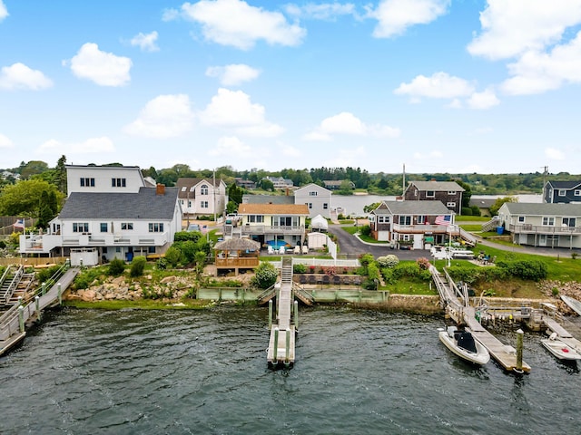 water view featuring a boat dock and nearby suburban area