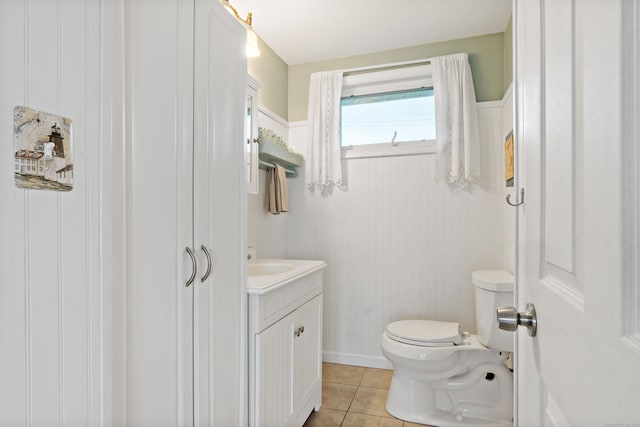 half bathroom featuring tile patterned floors and vanity