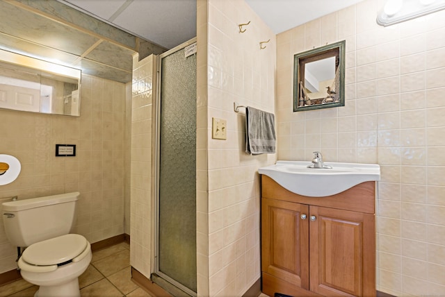 full bath featuring tile walls, a stall shower, tile patterned floors, and vanity