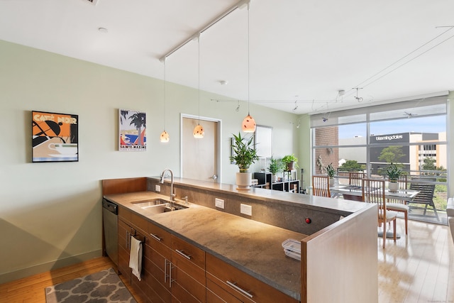 33 N Water St Unit 505, Norwalk, CT 06854 - kitchen with a peninsula, light wood-style floors, track lighting, stone counters, and white cabinetry