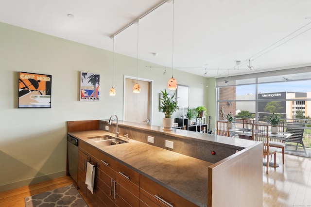 33 N Water St Unit 505, Norwalk, CT 06854 - kitchen featuring rail lighting, a peninsula, light wood-style flooring, and stainless steel dishwasher