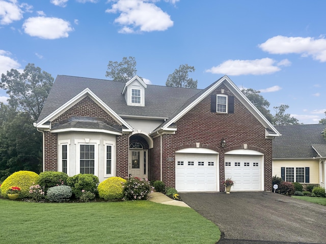 46 Sonoma Ln Unit 46, Middletown, CT 06457 - view of front of house with brick siding, asphalt driveway, a front yard, and roof with shingles