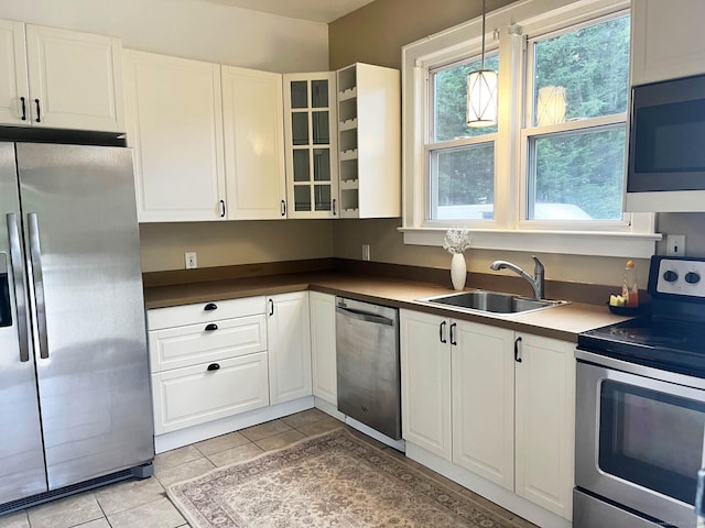 84 Strawberry Hill Ave, Norwalk, CT 06855 - kitchen featuring appliances with stainless steel finishes, white cabinets, and light tile patterned floors