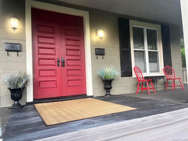 84 Strawberry Hill Ave, Norwalk, CT 06855 - doorway to property featuring a porch and a garage