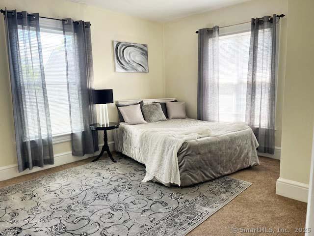 84 Strawberry Hill Ave, Norwalk, CT 06855 - bedroom with multiple windows and carpet floors