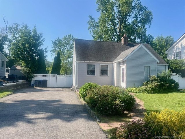 32 Beaver Hill Rd, Greenburgh, NY 10523 - view of property exterior with a chimney and asphalt driveway