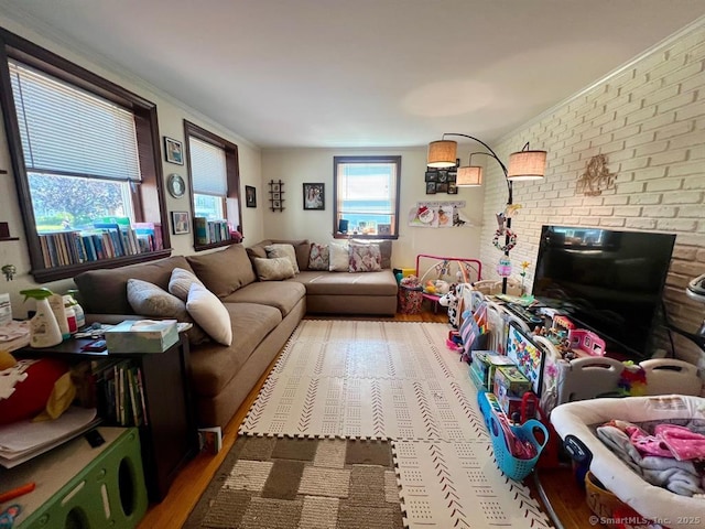 32 Beaver Hill Rd, Greenburgh, NY 10523 - living room featuring wood finished floors, brick wall, and ornamental molding