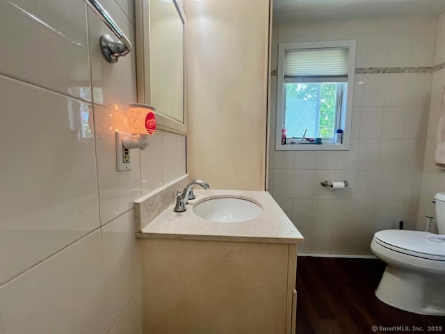 32 Beaver Hill Rd, Greenburgh, NY 10523 - bathroom featuring vanity, wood finished floors, and tile walls