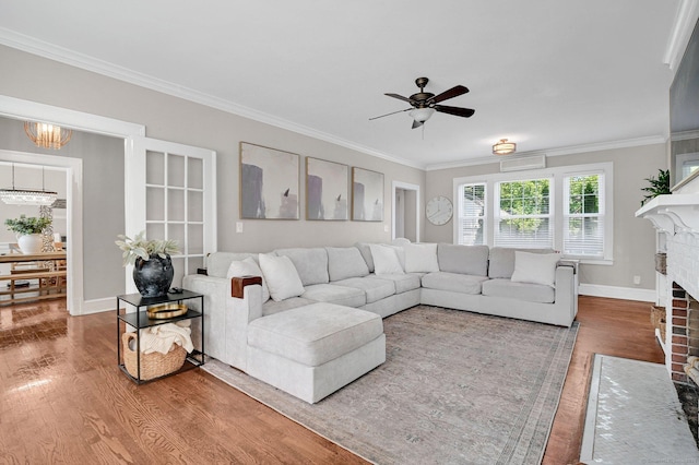 1676 Boulevard Blvd, West Hartford, CT 06107 - living room with wood finished floors, a fireplace, ornamental molding, a ceiling fan, and a chandelier