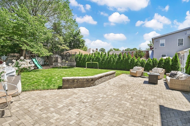 1676 Boulevard Blvd, West Hartford, CT 06107 - fenced backyard with a trampoline, a patio, a playground, and an outdoor living space with a fire pit