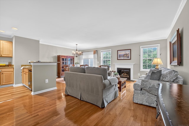 1401 Pinnacle Way Unit 1401, Danbury, CT 06811 - living area with ornamental molding, a chandelier, light wood-style floors, and a fireplace with flush hearth