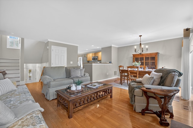 1401 Pinnacle Way Unit 1401, Danbury, CT 06811 - living room with light wood-style floors, a chandelier, stairway, and ornamental molding