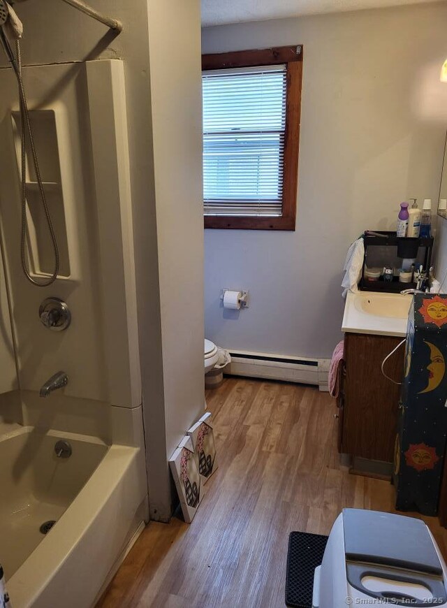 267 Chapman St, New Britain, CT 06051 - full bath with a baseboard radiator, vanity, wood finished floors, and tub / shower combination