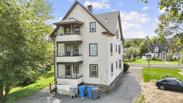 116 Divinity St, Bristol, CT 06010 - view of front of house with a balcony, a chimney, and a shingled roof