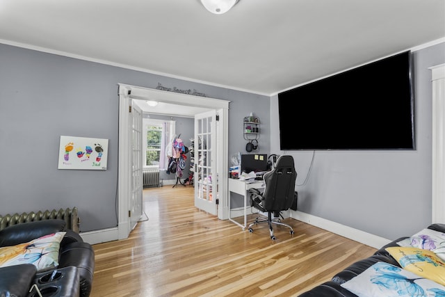 116 Divinity St, Bristol, CT 06010 - bedroom with radiator heating unit, light wood-style floors, crown molding, a desk, and french doors