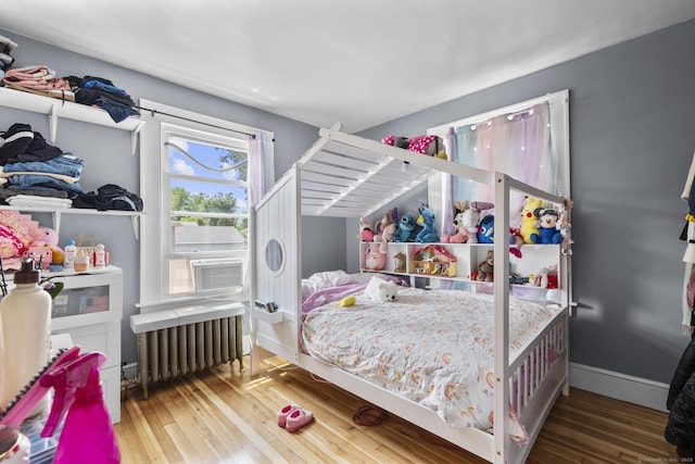 116 Divinity St, Bristol, CT 06010 - bedroom with radiator heating unit, hardwood / wood-style floors, and cooling unit