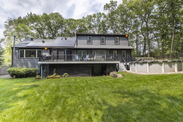 17 Kathleen Dr, Stratford, CT 06614 - rear view of property featuring a covered pool, a deck, solar panels, and a yard