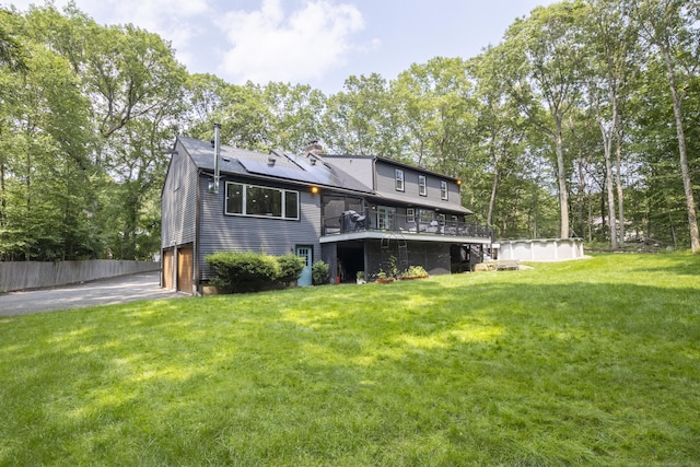17 Kathleen Dr, Stratford, CT 06614 - rear view of property featuring an attached garage, driveway, a deck, a chimney, and view of scattered trees