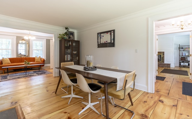 17 Kathleen Dr, Stratford, CT 06614 - dining space with a chandelier, ornamental molding, and light wood-style floors