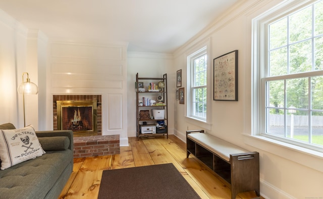 17 Kathleen Dr, Stratford, CT 06614 - living room featuring plenty of natural light, a fireplace, wood-type flooring, and ornamental molding