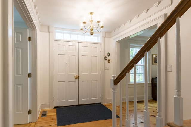 17 Kathleen Dr, Stratford, CT 06614 - entryway with a chandelier, stairs, and light wood finished floors