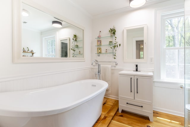 17 Kathleen Dr, Stratford, CT 06614 - bathroom featuring crown molding, a soaking tub, vanity, and a wainscoted wall