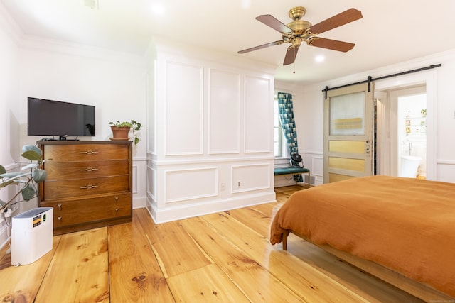 17 Kathleen Dr, Stratford, CT 06614 - bedroom with crown molding, a barn door, light wood-style floors, a decorative wall, and a ceiling fan