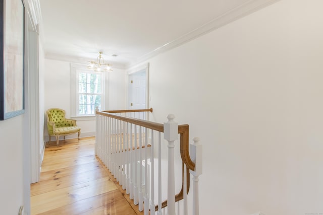17 Kathleen Dr, Stratford, CT 06614 - corridor featuring an upstairs landing, a chandelier, crown molding, and light wood-style floors
