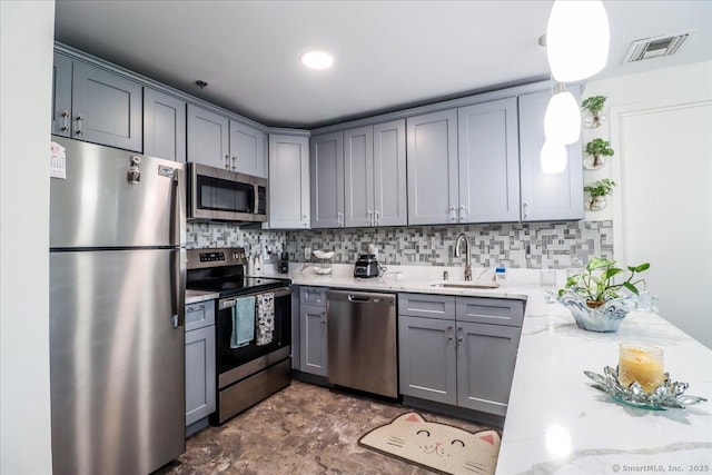 59 Courtland Ave Apt 3Q, Stamford, CT 06902 - kitchen with stainless steel appliances, gray cabinets, backsplash, and light stone countertops