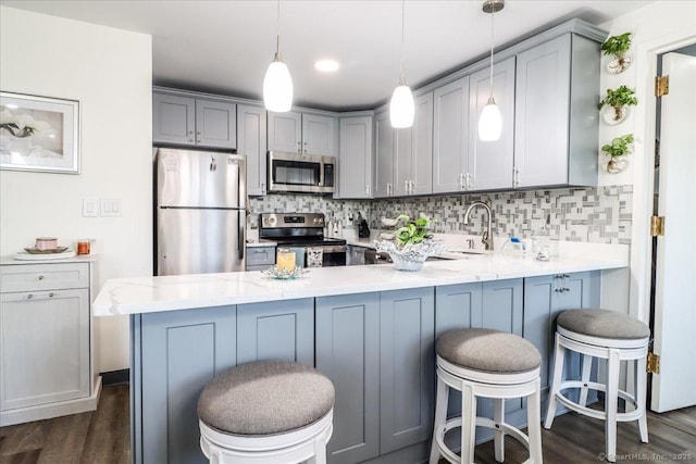 59 Courtland Ave Apt 3Q, Stamford, CT 06902 - kitchen featuring appliances with stainless steel finishes, a peninsula, dark wood-type flooring, and gray cabinets