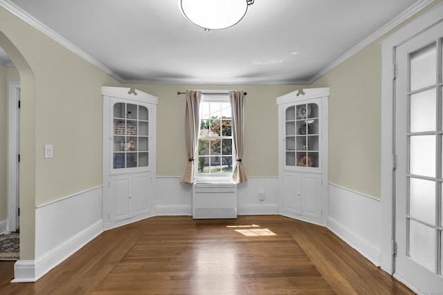 35 Brower St, West Haven, CT 06516 - unfurnished dining area featuring arched walkways, wood finished floors, and crown molding