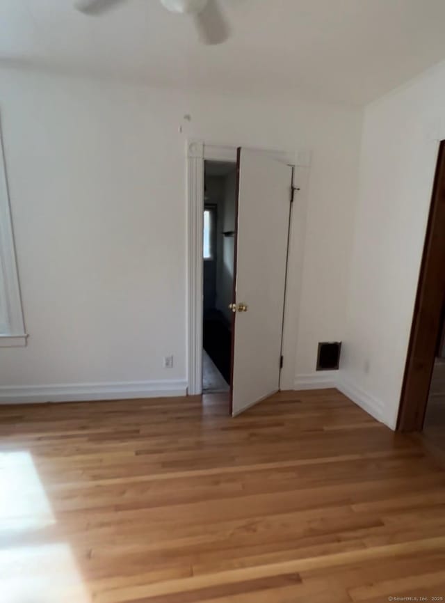 228 Elm St, Meriden, CT 06450 - empty room with light wood finished floors and a ceiling fan