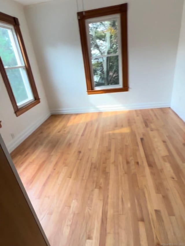 228 Elm St, Meriden, CT 06450 - empty room featuring plenty of natural light and light wood-style floors