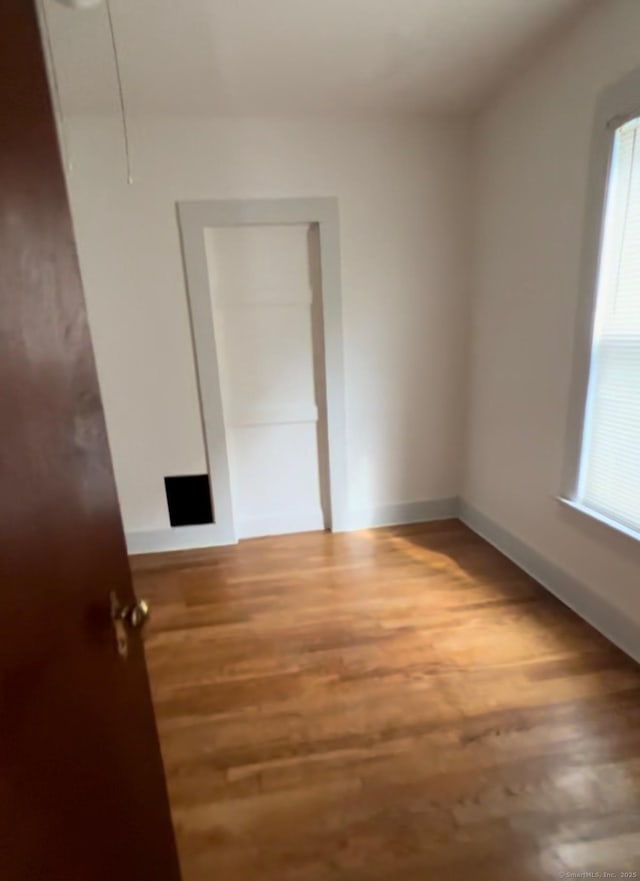 228 Elm St, Meriden, CT 06450 - unfurnished bedroom featuring wood finished floors