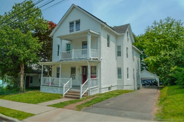 228 Elm St, Meriden, CT 06450 - view of front of home with covered porch, a balcony, an outbuilding, and a front lawn