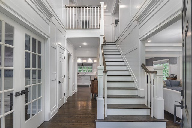 319 Mountain Rd, Wilton, CT 06897 - foyer entrance featuring crown molding, plenty of natural light, dark wood-style flooring, and stairway