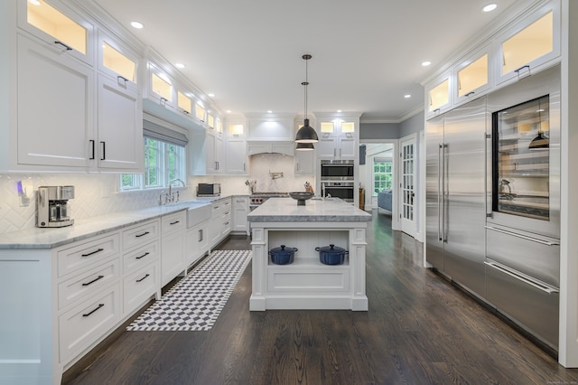 319 Mountain Rd, Wilton, CT 06897 - kitchen featuring dark wood-style floors, ornamental molding, oven, white cabinets, and recessed lighting