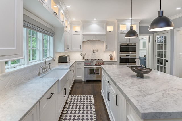 319 Mountain Rd, Wilton, CT 06897 - kitchen featuring stainless steel appliances, white cabinetry, light stone counters, a center island, and backsplash