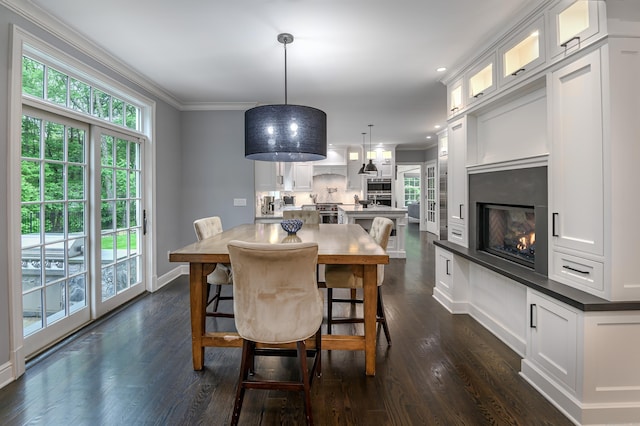 319 Mountain Rd, Wilton, CT 06897 - dining room with ornamental molding, dark wood-style flooring, a glass covered fireplace, and recessed lighting