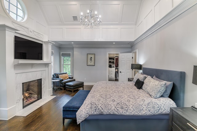 319 Mountain Rd, Wilton, CT 06897 - bedroom featuring a chandelier, dark wood-style flooring, crown molding, a high end fireplace, and a spacious closet