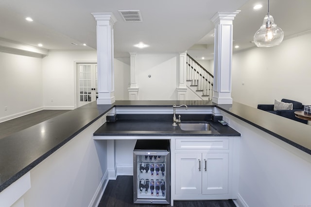 319 Mountain Rd, Wilton, CT 06897 - indoor bar with ornate columns, dark wood-type flooring, recessed lighting, and decorative light fixtures
