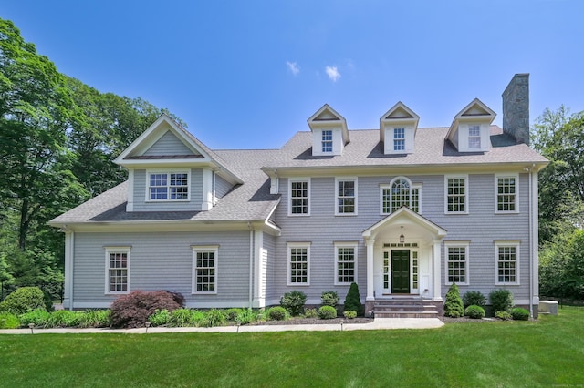 319 Mountain Rd, Wilton, CT 06897 - colonial inspired home featuring a front yard, a chimney, and a shingled roof