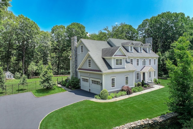 319 Mountain Rd, Wilton, CT 06897 - view of front of home featuring a chimney, driveway, and view of wooded area