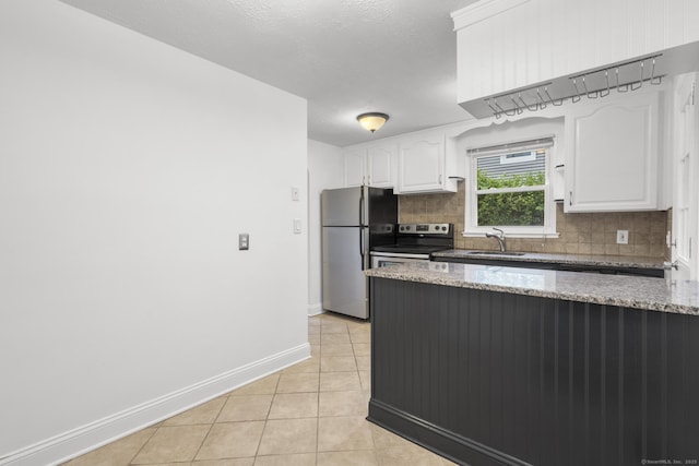 80 Holly St, Milford, CT 06460 - kitchen featuring stainless steel appliances, decorative backsplash, white cabinetry, light tile patterned floors, and light stone countertops