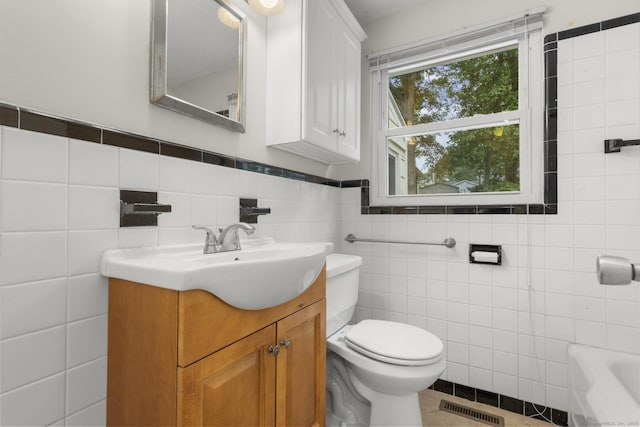 80 Holly St, Milford, CT 06460 - full bathroom featuring vanity, tile walls, and a bathtub